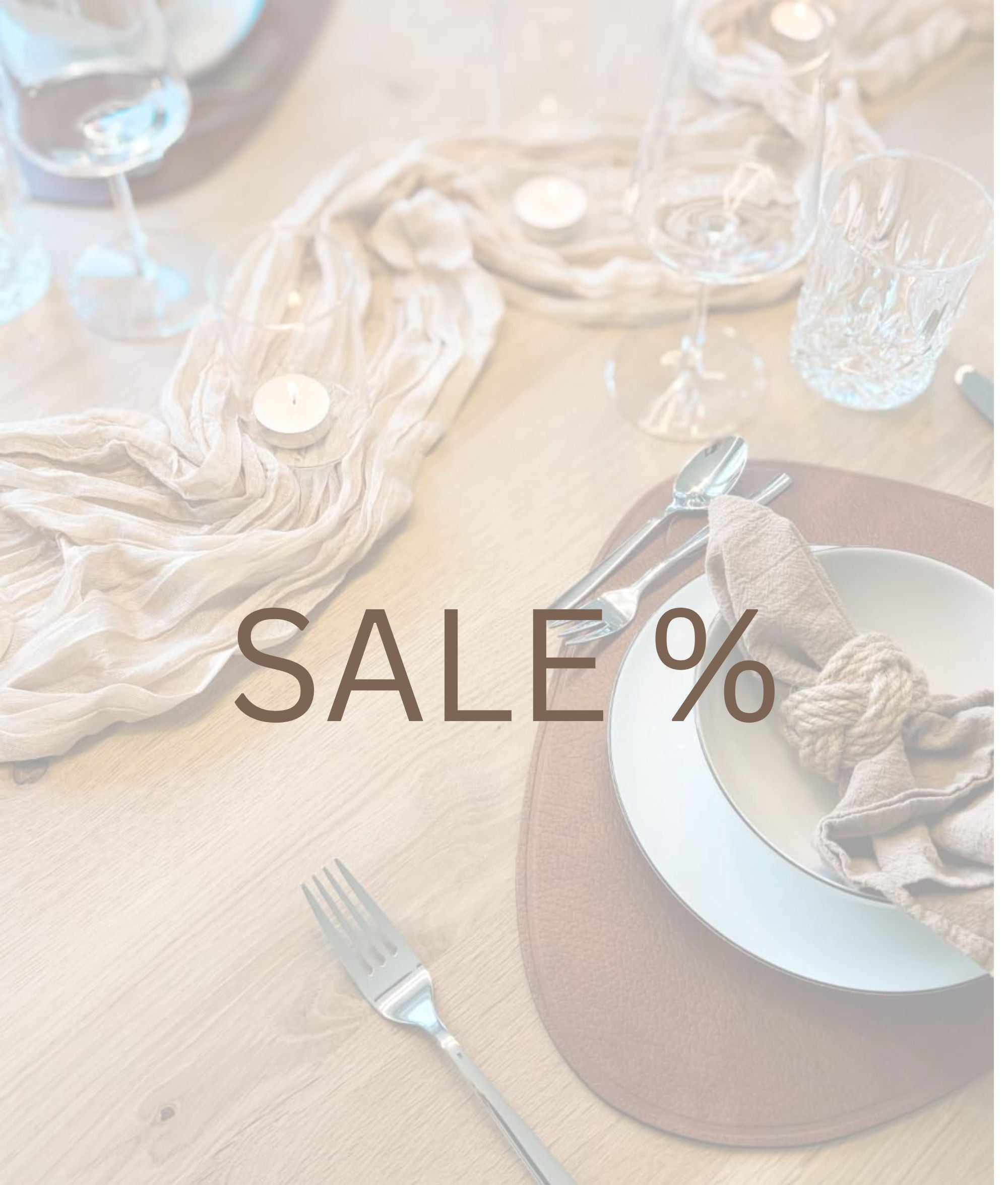 Sale Kategorie mit stilvoller Wohn-Deko in Naturtönen, Kerze, Schere, Stoffen und Accessoires auf hellem Hintergrund